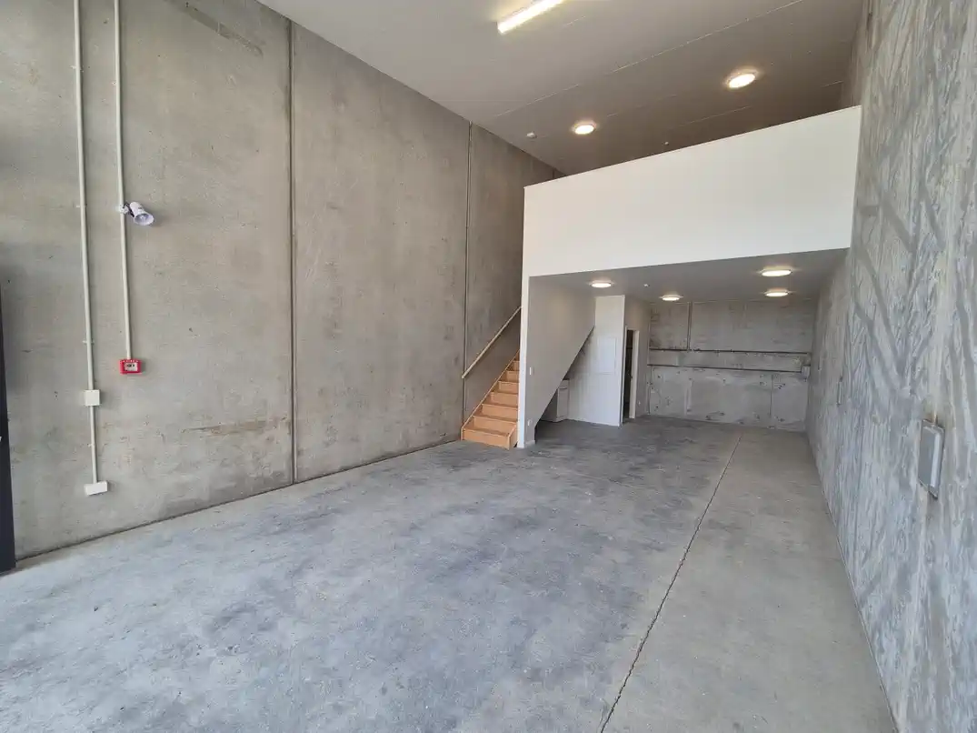 Interior ground floor wide shot with stairs to mezzanine