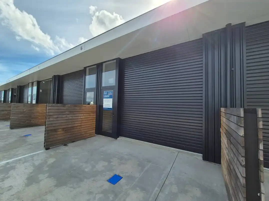 Unit 6 exterior with roller door closed and For Lease sign