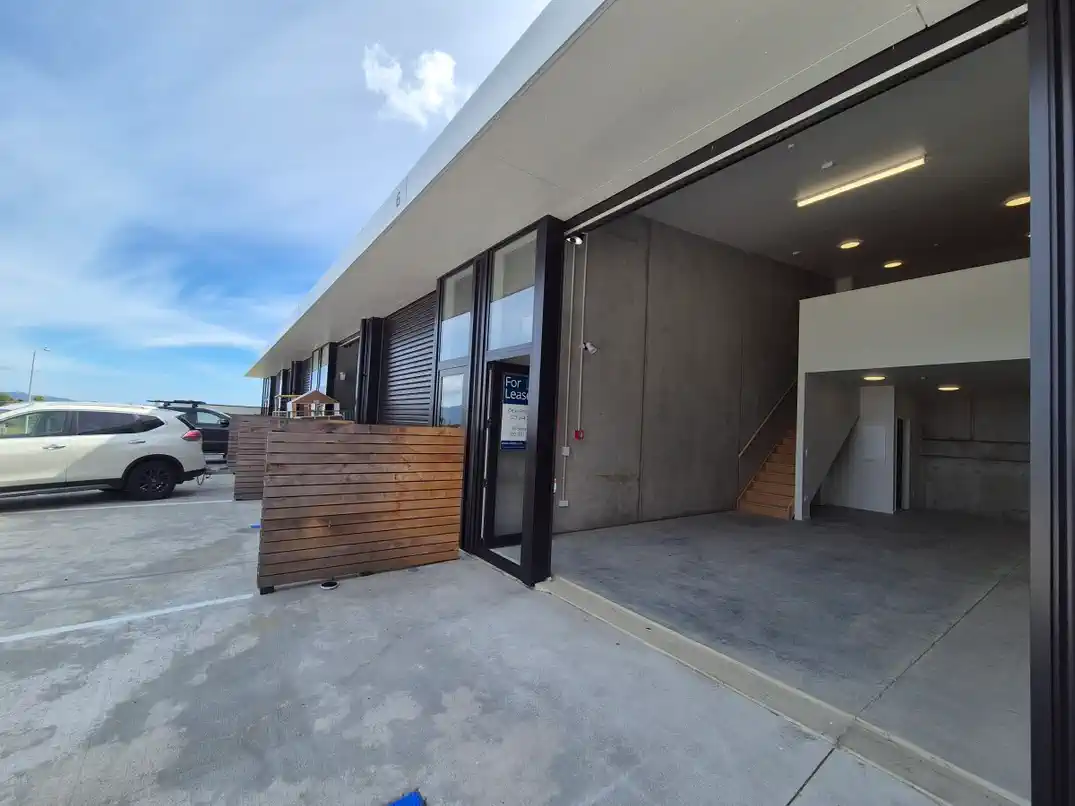 Unit 6 exterior with roller door open, showing mezzanine and stairs inside